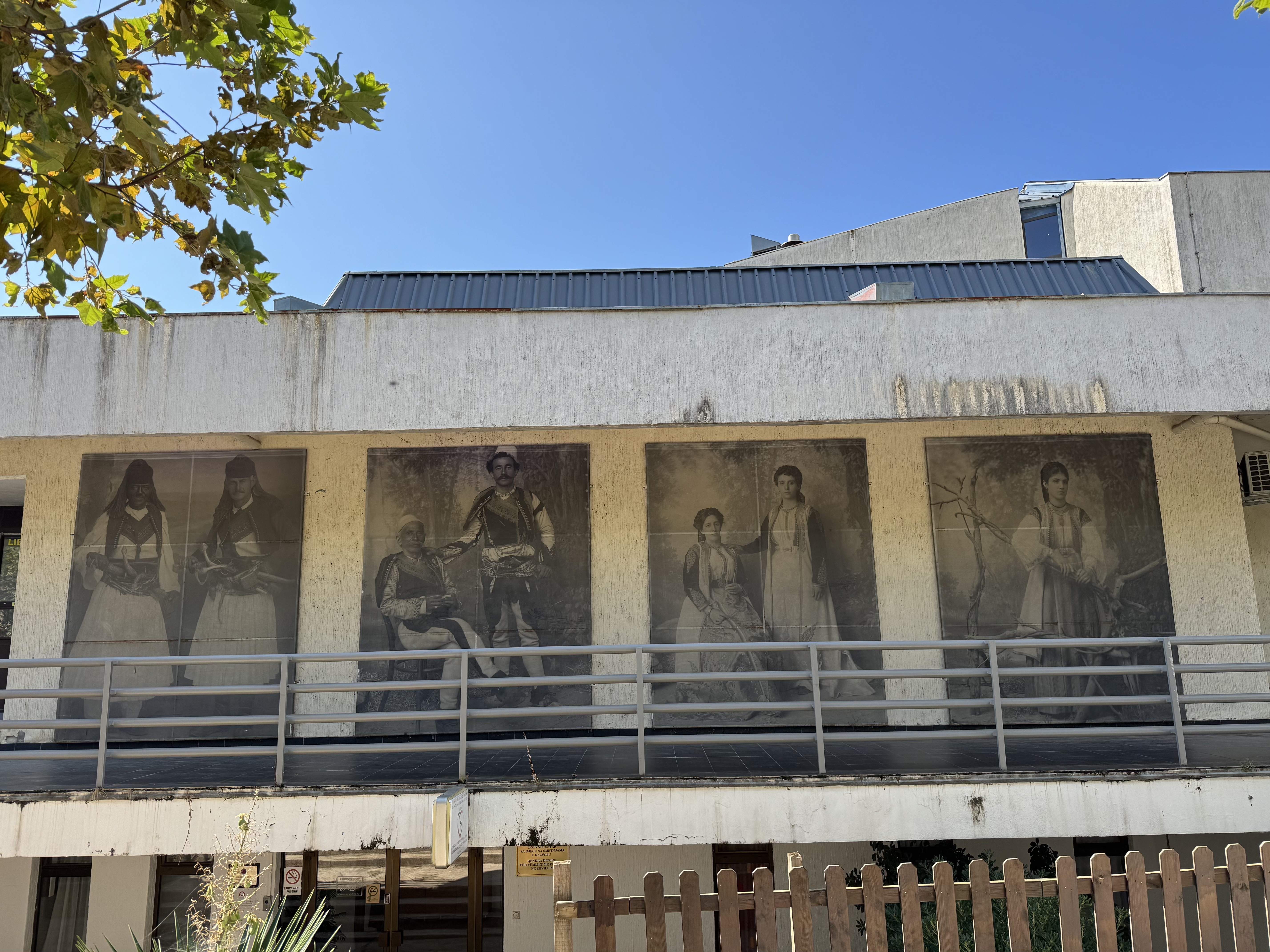 The four Marubi photographs displayed on the library wall